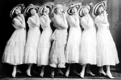 chorus line on stage in white muslin 